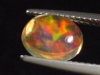 Fire Opal 1,57 Ct. fine colorplay - oval cabochon Mexico