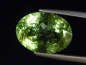 Preview: Peridot mit dekorativen Einschlüssen 8,39 Ct. Oval 15 x 11 mm Pak.