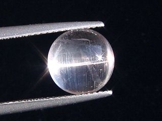 Skapolite cat's eye 3,52 Ct. colorless round cabochon Tanzania
