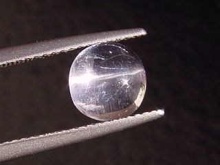 Petschite / violet Skapolite cat's eye 1,70 Ct. round cabochon Tanzania