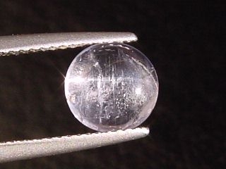 Petschite / violet Skapolite cat's eye 1,64 Ct. round cabochon Tanzania