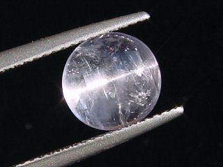 Petschite / violet Skapolite cat's eye 2,43 Ct. round cabochon Tanzania