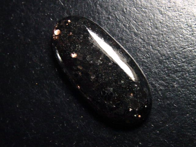 Bronzite 28,77 Ct. oval cabochon with fine shimmer